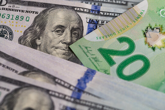 US hundred dollar bill and Canadian twenty dollar banknote close up