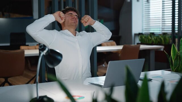 Sleepy busy tired Caucasian business man typing laptop yawning stretching hands feeling discomfort fatigued businessman work computer yawn stretch at table in evening office male guy employer late job