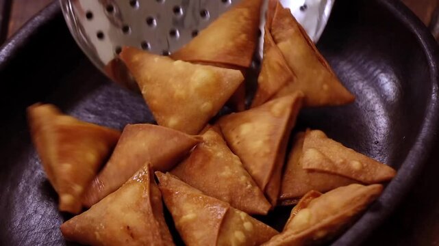 Stuffed meat samosa fried crispy and served as snack in closeup. Ideal for samosa, snack, appetizer and dish visuals with crunchy texture and restaurant style presentation.