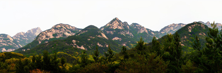 Fototapeta premium Panoramic Foggy Bukhansan Mountain landscape above northern Seoul, its three granite peaks reaching 2,744 feet, overlooking the city with timeless natural beauty