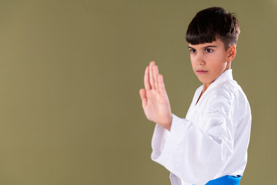 Young karate student performs a Shotokan knife hand block , shuto uke , demonstrating precision, focus, and correct defensive form in training.