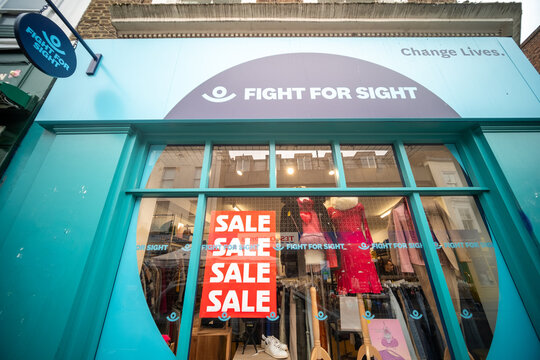 LONDON -  Fight for Sight turquoise charity shop with sale signage on Portobello Road Notting Hill