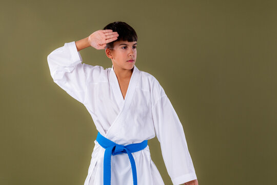 Close-up view of a karate student performing age uke, highlighting correct hand placement and defensive form.