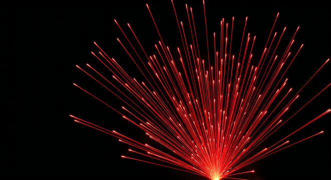 A vibrant burst of red light streaks emanate from a central point in darkness