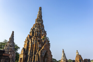 Majestic ancient stone temple ruin stands Ayutthaya Thailand blue sky presenting historical pagoda architecture evoking serene emotion and awe inspiring peaceful feeling for every visitor © CoreRock