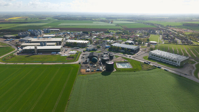 Aerial view of a modern agricultural grain storage facility and rural industrial business park in Lincolnshire, UK.