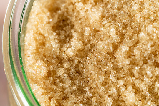 Natural can sugan in a glass jar on a tile surface 