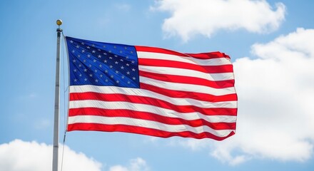 Fototapeta premium Celebrating flag day a vibrant american flag waving proudly against a beautiful blue sky with clouds