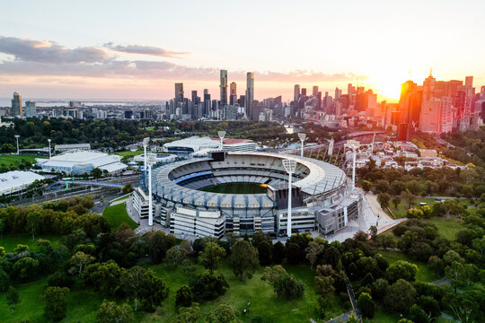 Aerial view of the Melbourne Cricket Ground (MCG) at sunset with city skyline