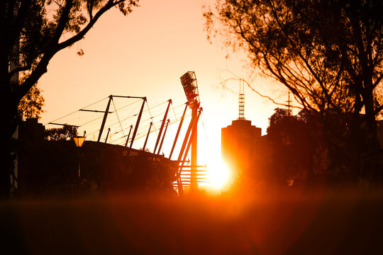 A Melbourne Cricket Ground (MCG) light tower can be seen at sunset on a clear night