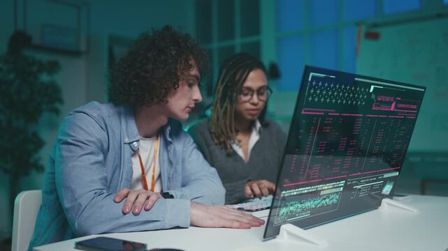 Multiethnic software developers successfully run code on futuristic interface