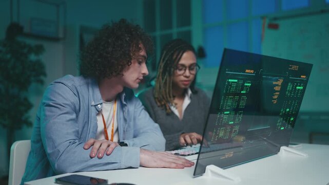 Two programmers launch new software on futuristic computer and share a high five