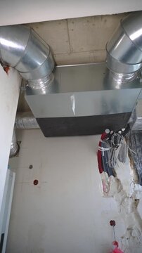 Technician assembling insulated ducts and sealing joints securely