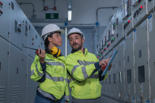 engineer working on the checking status switchgear electrical energy distribution substation	