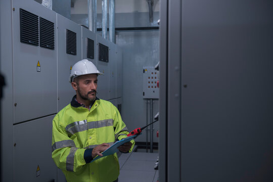 engineer working on the checking status switchgear electrical energy distribution substation	