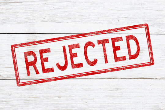 Rejected red distressed stamp on weathered wood