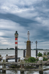 Fototapeta premium The statue of Mary at the harbor entrance in Volendam on the North Sea coast.
