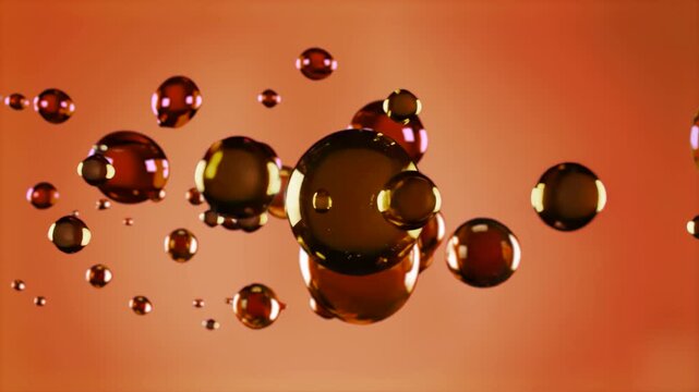 Dense, dark red or brown spheres float through a warm orange-red liquid, resembling oil droplets, plasma, or particles. The animation shows them interacting and colliding, suitable for medical animati