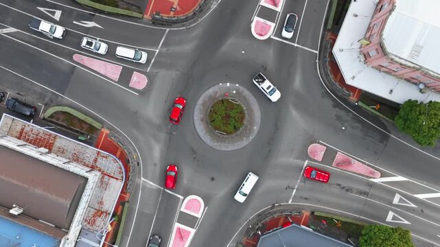 Aerial view of a roundabout in  Stratford, Taranaki, New Zealand, with cars navigating the intersection. The traffic flows smoothly, showcasing urban infrastructure.