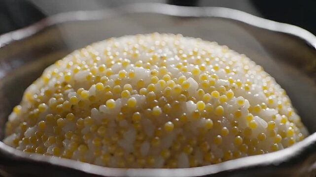 Closeup of a steaming bowl of tapioca pearls in a silver bowl.
