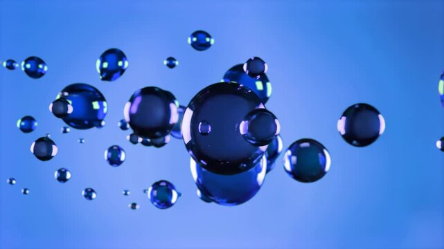 Various sizes of blue spheres, representing oil droplets or gel particles, float suspended in a blue liquid. The animation shows the spheres moving and merging, suitable for science visualizations, co