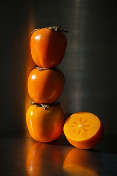 three persimmons stacked on top of each other