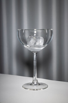 empty wine glass with ice cube