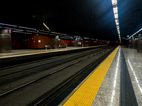 Empty subway station platform with train tracks