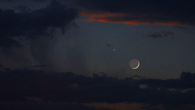 Blue hour time with crescent Moon, stars and planets.