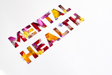 Fototapeta premium “Mental Health” text cut out in negative, with flowers inside
