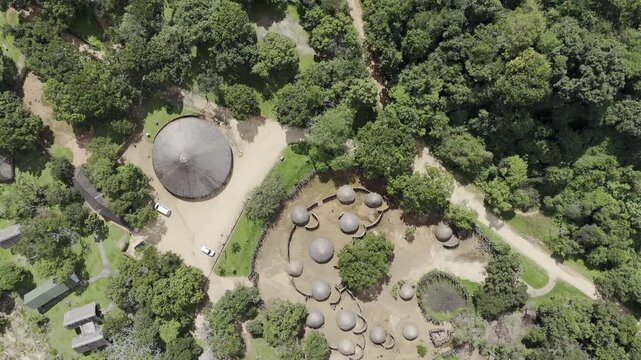 Drone flies over Mantenga Cultural Village in a bird's eye shot on a sunny day in Ezulwini, Eswatini
