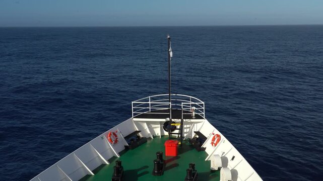 Antarctic expedition. Boat travels over calm sea with clear sky near coast on a sunny day. Antarctic Peninsula