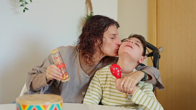 Mother and disabled son enjoying music therapy together at home