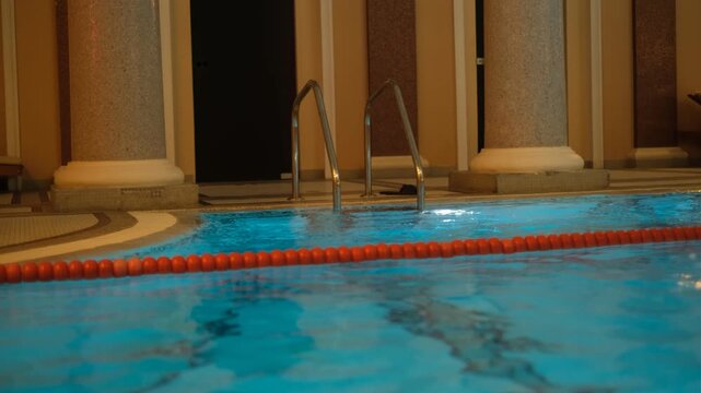 Empty gym pool with ladder
