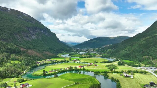 Aerial of a river winding through meadows and farmland near the town of Stryn Norway.