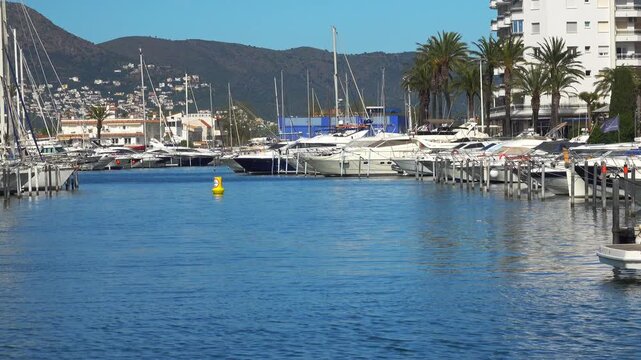 Boats are parked in the marina under a blue sky. Empuriabrava, Spain
