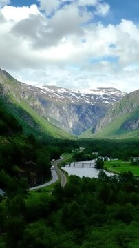 Aerial of the Rauma river winding through meadows and farmland in the Romsdalen Valley in Norway.