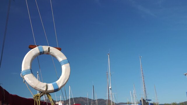 A lifebuoy is seen on a rope near the dock