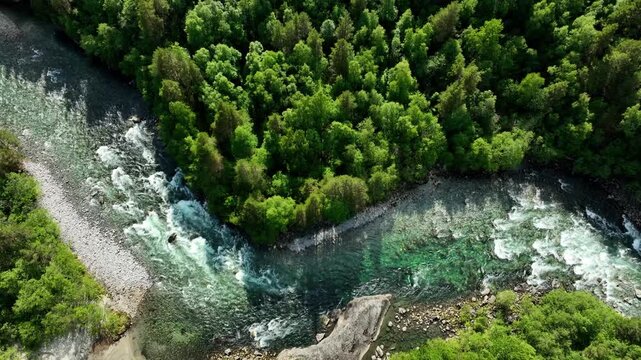 Aerial of the Rauma river winding through meadows and farmland in the Romsdalen Valley in Norway.