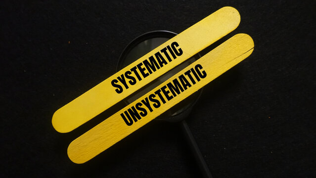 Two yellow sticks with contrasting words systematic and unsystematic
