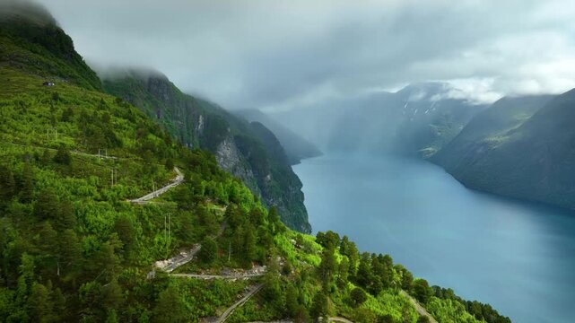 Aerial shot of the Geiranger Fjord meeting the mountains along the beautiful coast of Norway.