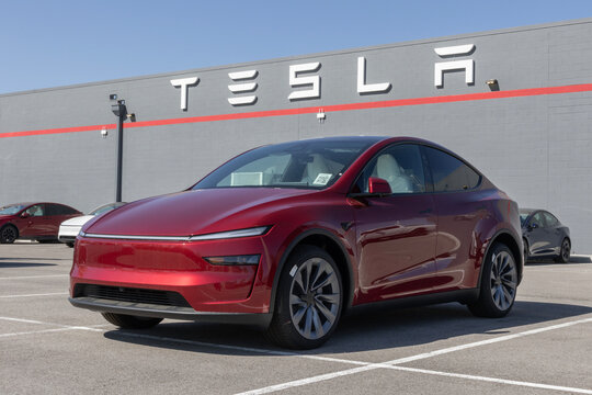 Tesla Model Y display at a dealership. Tesla offers the Model Y with up to 327 miles of driving range. MY:2026