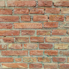 Fototapeta premium Weathered brick wall texture background with rustic red and orange tones