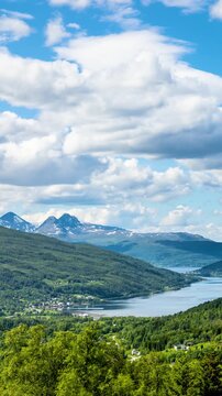 Time lapse of the clouds moving above the  amazing coastline and mountains of Norway. Vertical video.