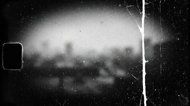 Vintage Film Grain Overlay with Cityscape Silhouette and Light Leaks.