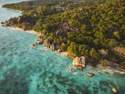 Aerial view of Anse Source d'Argent beach featuring iconic granite boulders, turquoise waters, and lush tropical forest in L'Union Estate, Seychelles.