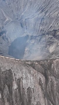 Aerial shot of the active valcano Mount Bromo in Indonesia. Vertical Video.