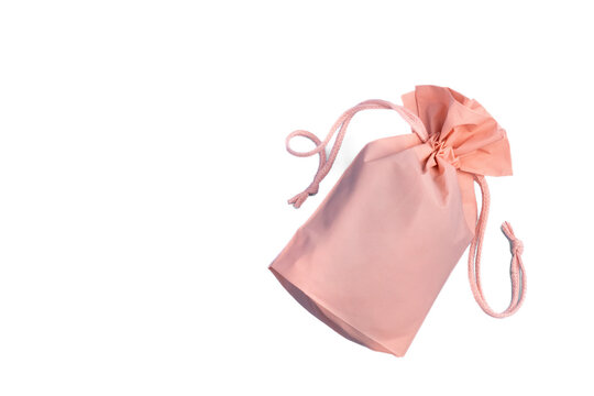 A soft pink fabric drawstring pouch isolated on a clean white background