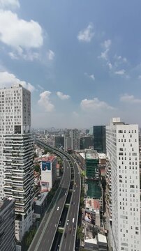 Fixed timelapse of Mexico City urban skyline with elevated highway and skyscrapers from a high-rise building