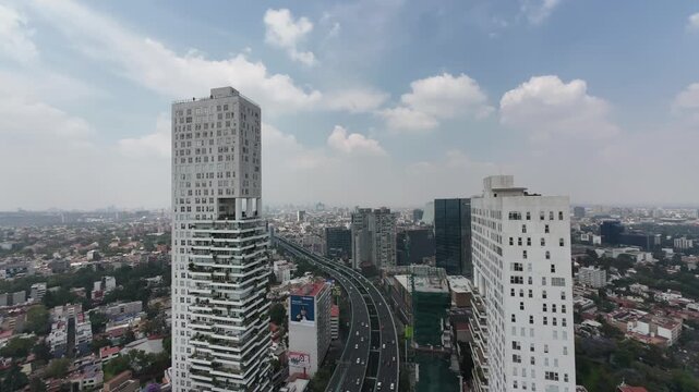 Timelapse of residential towers and traffic on Perif&eacute;rico highway with hazy skyline in M&eacute;xico City. Shot in D-Log M 